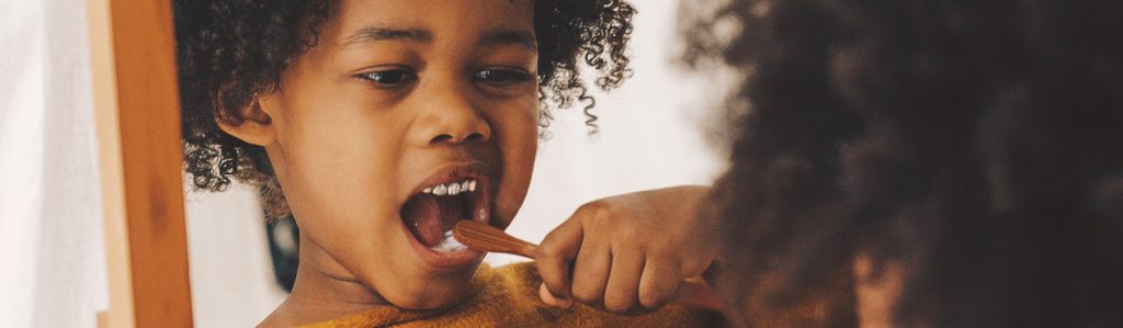 kid brushing her teeth 1920x560